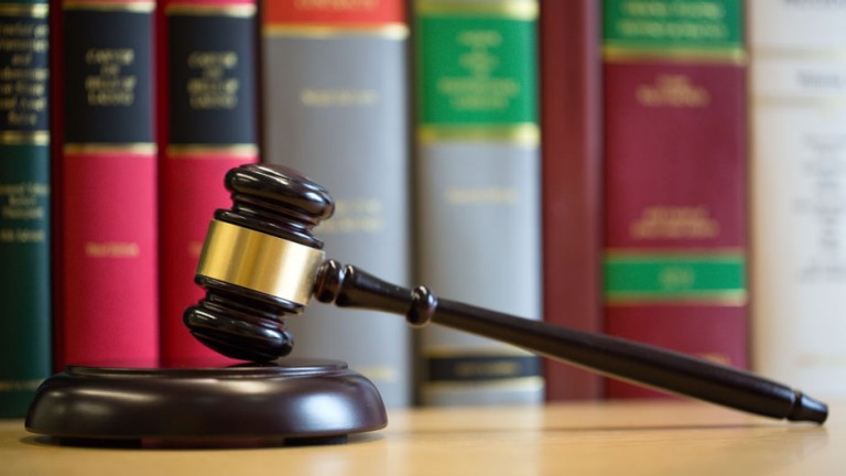 Gavel on table with legal books in the background